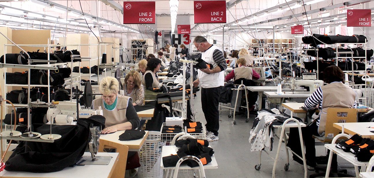 Industrial engineers conducting time study on a garment factory floor